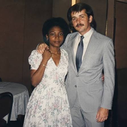 A couple dressed formally and standing together at a celebration